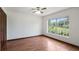 This bedroom features wood floors, a large window and trim at 17825 Whisperwind Dr, Clermont, FL 34715