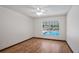 Bedroom features wood floors, a large window with a view of the pool at 17825 Whisperwind Dr, Clermont, FL 34715
