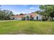Charming single-story home with a well-manicured lawn, beautiful landscaping, and a welcoming facade at 17825 Whisperwind Dr, Clermont, FL 34715