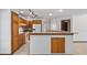 Stylish kitchen with stainless steel appliances, wood cabinetry, and a granite island with seating at 17825 Whisperwind Dr, Clermont, FL 34715