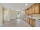 Bright kitchen features tile floors, wood cabinets, white appliances and lots of natural light at 17825 Whisperwind Dr, Clermont, FL 34715