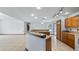 Spacious kitchen featuring a granite-topped island bar with a clear view to the pool at 17825 Whisperwind Dr, Clermont, FL 34715