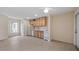 Bright kitchen features tile floors, wood cabinets, white appliances and lots of natural light at 17825 Whisperwind Dr, Clermont, FL 34715