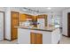 Well-lit kitchen featuring wood cabinetry, granite countertops, and modern appliances at 17825 Whisperwind Dr, Clermont, FL 34715