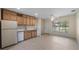 Bright kitchen features tile floors, wood cabinets, white appliances and lots of natural light at 17825 Whisperwind Dr, Clermont, FL 34715