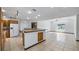 Open kitchen layout with expansive island, wood cabinets, and ample living space at 17825 Whisperwind Dr, Clermont, FL 34715