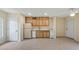 Bright kitchen features tile floors, wood cabinets, white appliances and lots of natural light at 17825 Whisperwind Dr, Clermont, FL 34715