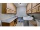 Bright laundry room featuring upper cabinets, spacious counters, and a convenient utility sink at 17825 Whisperwind Dr, Clermont, FL 34715