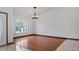Inviting living room with hardwood floors, large windows, and neutral paint, creating a bright and airy space at 17825 Whisperwind Dr, Clermont, FL 34715