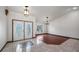 Bright living room featuring tile and wood flooring, stylish light fixtures, and a decorative front door at 17825 Whisperwind Dr, Clermont, FL 34715