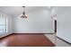 Spacious living room with vaulted ceilings, wood floors, and a large window providing ample natural light at 17825 Whisperwind Dr, Clermont, FL 34715