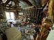 Unfinished basement with exposed ceiling, concrete flooring, and an abundance of items at 1920 Baxter Ave, Orlando, FL 32806