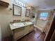 Bathroom featuring a double sink vanity with brick flooring and a shower/tub combination at 1920 Baxter Ave, Orlando, FL 32806