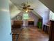 Attic bedroom featuring a ceiling fan, a window, and laminate wood flooring at 1920 Baxter Ave, Orlando, FL 32806