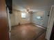 Spacious bedroom featuring hardwood floors, a ceiling fan, two windows, and ample natural light at 1920 Baxter Ave, Orlando, FL 32806