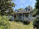Charming blue two-story home with a cozy front porch and dormer windows at 1920 Baxter Ave, Orlando, FL 32806