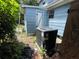 Side of home showing AC unit and blue outbuilding at 1920 Baxter Ave, Orlando, FL 32806