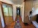 Hallway with wood paneling, hardwood floors, and an oriental rug at 1920 Baxter Ave, Orlando, FL 32806