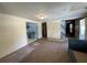 Living room featuring a doorway to the kitchen and carpeted floors at 1920 Baxter Ave, Orlando, FL 32806