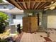 Covered patio with AC unit and wooden storage box at 1920 Baxter Ave, Orlando, FL 32806
