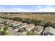 Aerial view of a well-kept neighborhood with manicured lawns near a large open field at 2036 Chesapeake Pl, The Villages, FL 32162