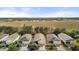 Aerial view of homes near an open field and a pond in a well-maintained neighborhood at 2036 Chesapeake Pl, The Villages, FL 32162