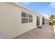 Backyard with a sliding glass door and concrete patio near a well-maintained yard at 2036 Chesapeake Pl, The Villages, FL 32162