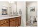 Bathroom with wood vanity, large mirror, and convenient walk-in shower at 2036 Chesapeake Pl, The Villages, FL 32162