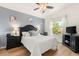 Bedroom featuring hardwood floors, a ceiling fan, a window with curtains, and black furniture at 2036 Chesapeake Pl, The Villages, FL 32162