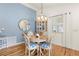 Cozy dining area features a round table, four chairs, and stylish light fixture at 2036 Chesapeake Pl, The Villages, FL 32162
