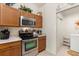 Updated kitchen showcases stainless steel appliances and plenty of cabinet space at 2036 Chesapeake Pl, The Villages, FL 32162