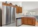 Modern kitchen featuring stainless steel appliances, granite countertops, and ample cabinet space at 2036 Chesapeake Pl, The Villages, FL 32162