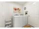 Convenient laundry room features a washer, dryer, and ample storage space at 2036 Chesapeake Pl, The Villages, FL 32162