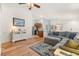 Open-concept living room with hardwood floors flows into kitchen and dining areas at 2036 Chesapeake Pl, The Villages, FL 32162