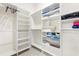 Spacious walk-in closet with custom shelving for optimal organization and storage solutions at 2036 Chesapeake Pl, The Villages, FL 32162