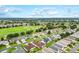 Panoramic aerial view of a charming neighborhood near a golf course, with manicured lawns and mature trees at 2120 Callaway Dr, The Villages, FL 32162