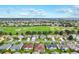 Stunning aerial shot of a neighborhood by a golf course, showcasing well-maintained lawns and serene surroundings at 2120 Callaway Dr, The Villages, FL 32162