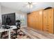 Multi-purpose room with large built-in cabinets, desk, and wood-look flooring at 2120 Callaway Dr, The Villages, FL 32162