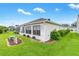 Exterior view of the home showcasing lush landscaping and a well-maintained lawn at 2120 Callaway Dr, The Villages, FL 32162