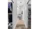 Hallway with two walk-in closets, and tile and wood-style floors at 2120 Callaway Dr, The Villages, FL 32162