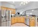 Modern kitchen with stainless steel appliances, light wood cabinetry, and ample counter space at 2120 Callaway Dr, The Villages, FL 32162