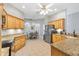 Spacious kitchen features granite countertops, stainless steel appliances, and a dining area at 2120 Callaway Dr, The Villages, FL 32162