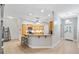 Well-lit kitchen featuring wood cabinets, granite countertops, and a breakfast bar at 2120 Callaway Dr, The Villages, FL 32162