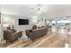 Comfortable living room with plank flooring, plenty of seating, and sliding glass doors to the lanai at 2120 Callaway Dr, The Villages, FL 32162