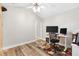 Office area with a large monitor, desk, modern fan and wood-look floors at 2120 Callaway Dr, The Villages, FL 32162
