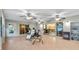 Bright sunroom featuring tile flooring, multiple ceiling fans, and sliding glass doors to the kitchen and backyard at 2120 Callaway Dr, The Villages, FL 32162