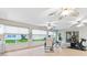 Enclosed sunroom area with multiple ceiling fans, tile floors, and an exercise bike at 2120 Callaway Dr, The Villages, FL 32162