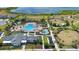 Stunning aerial view of a community pool, playground, and clubhouse next to a tranquil lake at 2202 Garden Belle Dr, Clermont, FL 34711