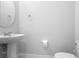 Clean half bathroom with pedestal sink, toilet, and neutral paint at 2202 Garden Belle Dr, Clermont, FL 34711
