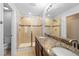 Beautifully designed bathroom with double sinks, granite countertops, and dual glass showers at 2202 Garden Belle Dr, Clermont, FL 34711